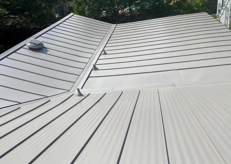 Solar attic fan installed on a metal roof for Roof Ventilation in Crystal City